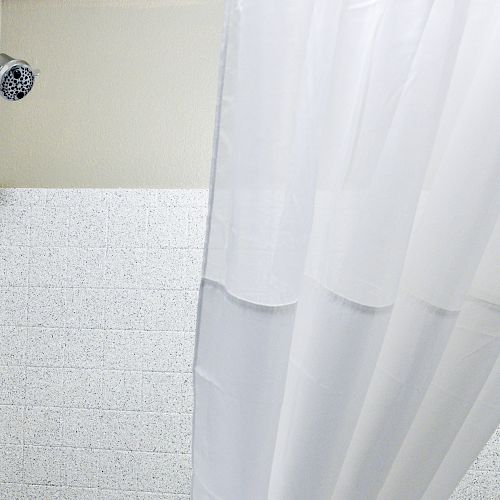 The image shows a shower area with white-tiled walls, a chrome showerhead, a faucet, and a white shower curtain partially drawn.